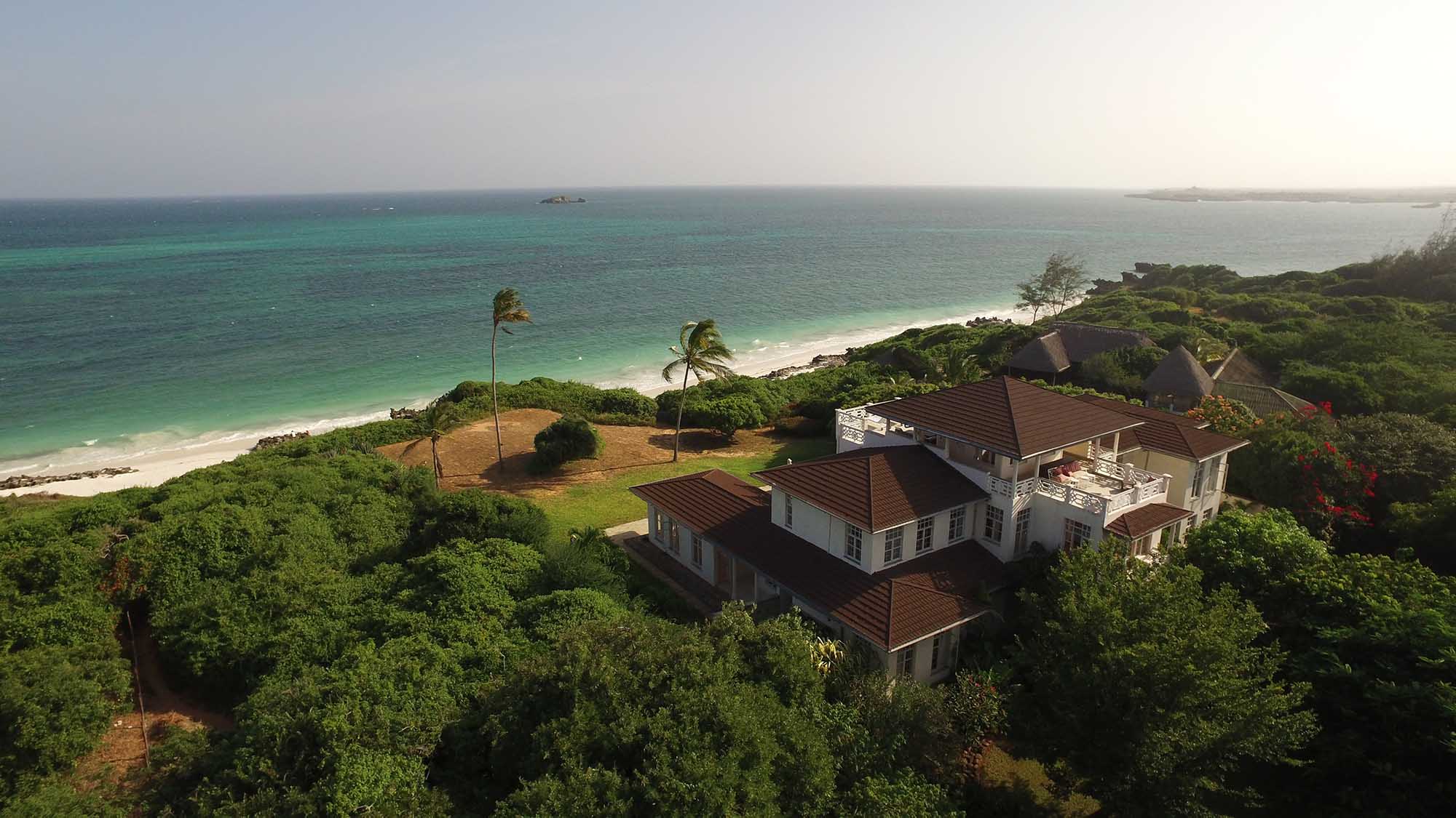 Aerial of East African coastline — turquoise reef and white beach